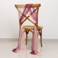 Mauve and blush sheer chair drapes on a wooden chair.