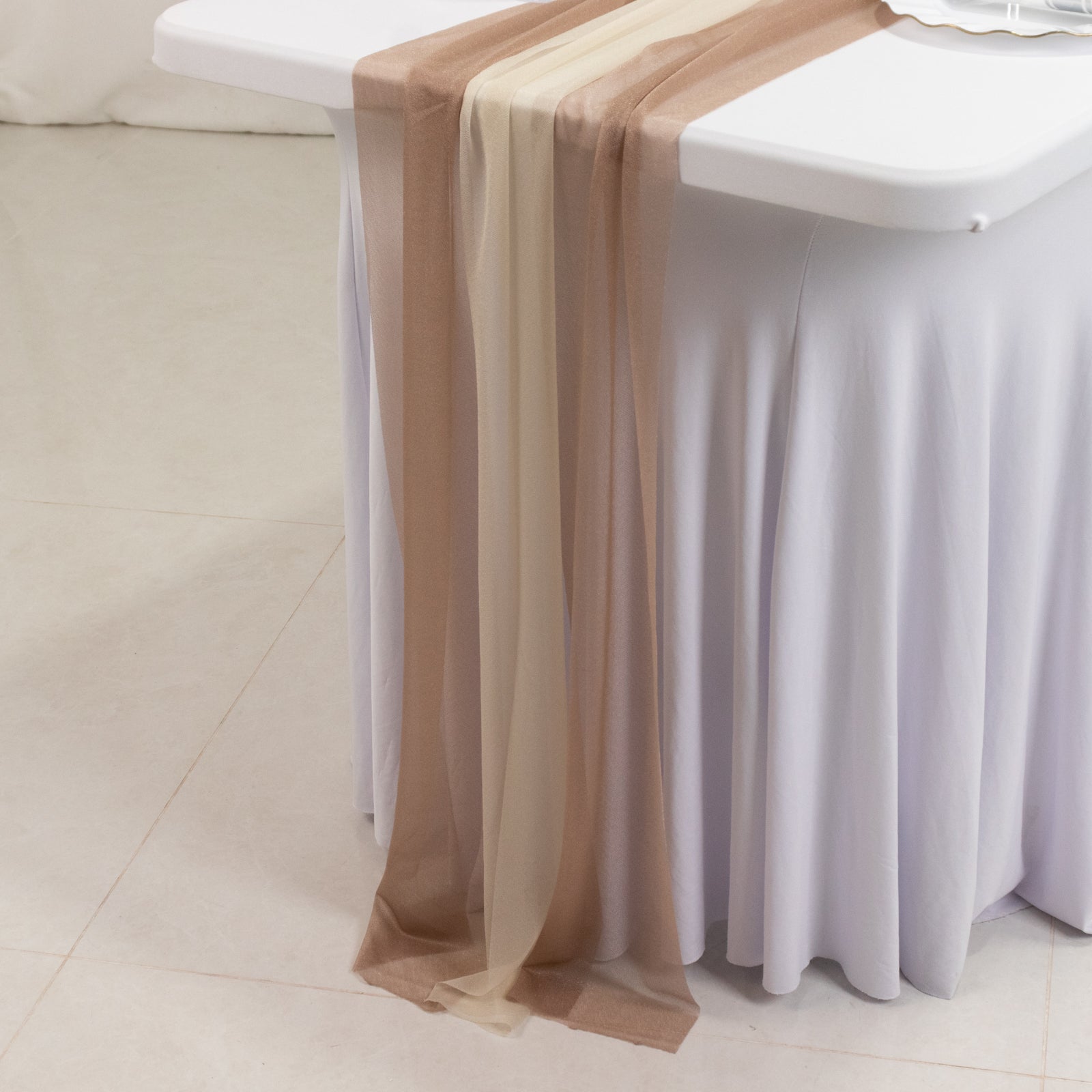 Taupe and beige shimmer sheer table runners on a white table.
