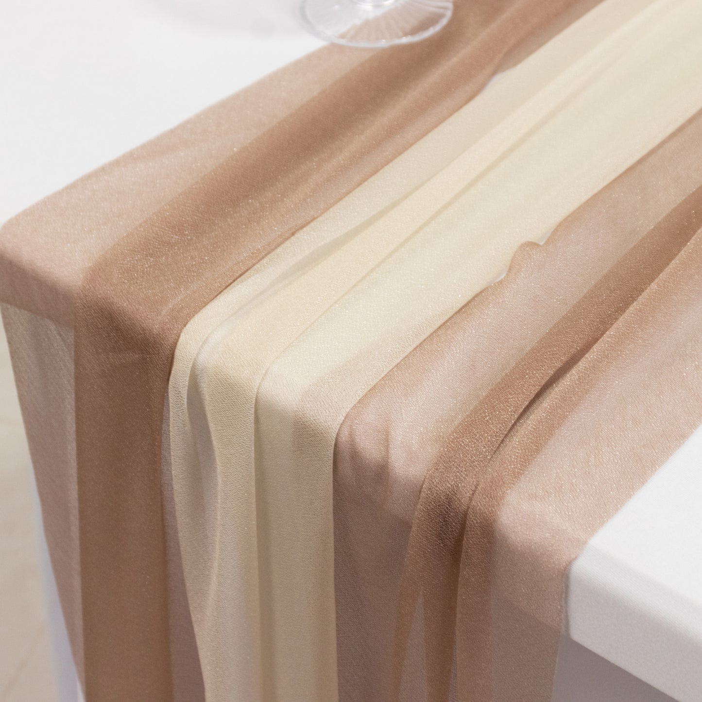 Taupe and beige shimmer sheer table runners on a white table.