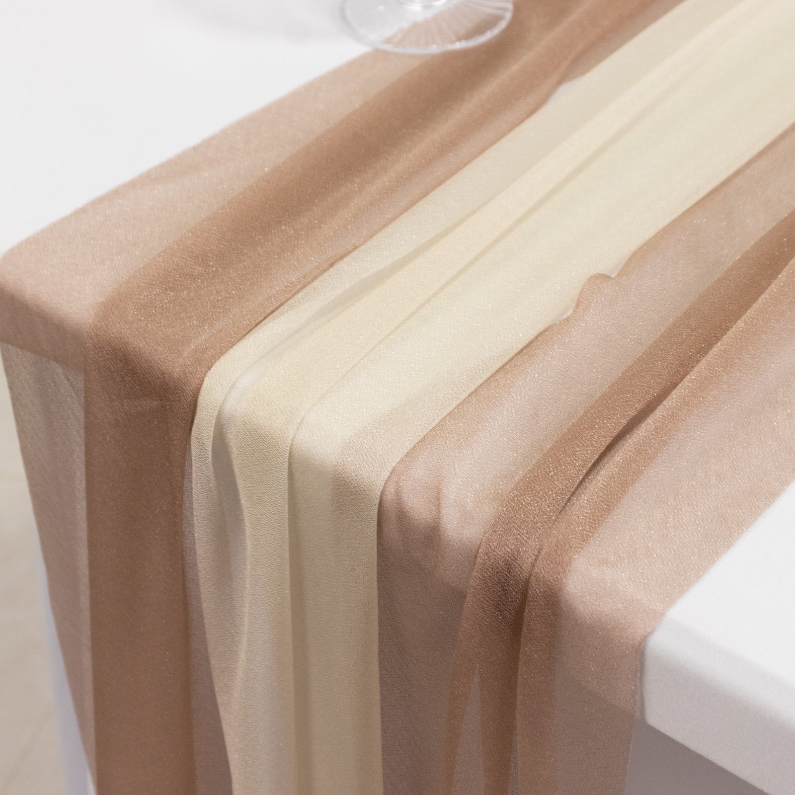 Taupe and beige shimmer sheer table runners on a white table.
