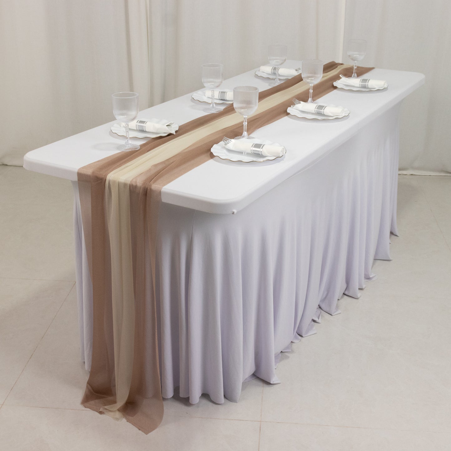 Taupe and beige sheer table runners on a white tablecloth.