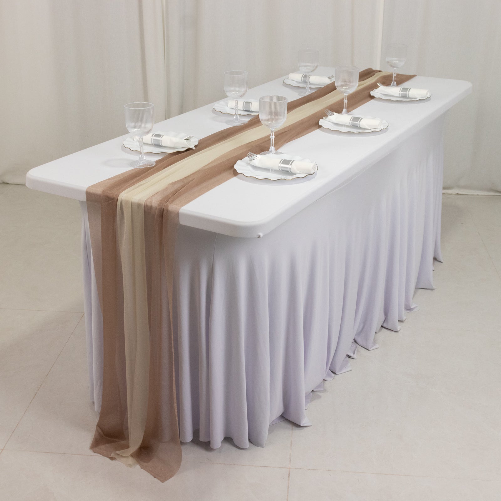 Taupe and beige sheer table runners on a white tablecloth.
