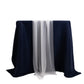 White shimmer sheer table runners on a dark navy tablecloth.