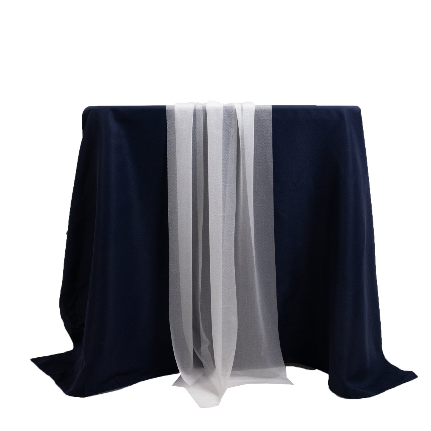 White shimmer sheer table runners on a dark navy tablecloth.
