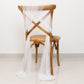 White sheer chair drape with 9ft shimmer sash on a wooden chair.