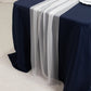 White shimmer sheer table runner on a navy blue table.