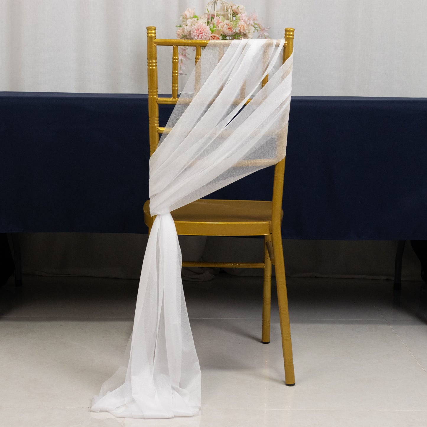 White sheer chair drape decor with 9ft shimmer sash on a gold chair.