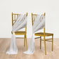 White sheer chair drape decor with shimmer sash on gold chairs.