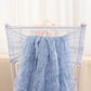 Dusty blue sheer crinkled organza chair sash on a transparent chair.