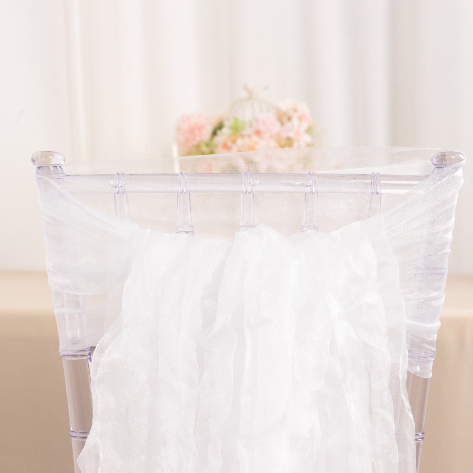 White sheer crinkled organza chair sashes for elegant decor.