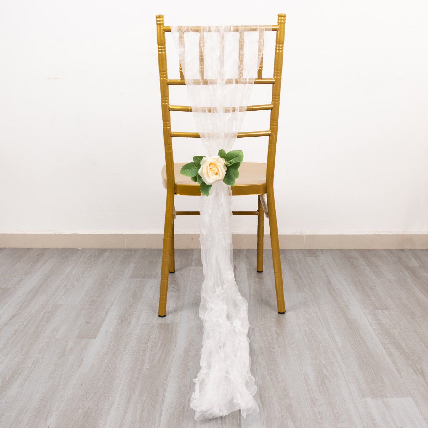 White sheer crinkled organza chair sash with a floral accent.