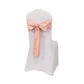 Dusty rose satin chair sash bow on a white chair.