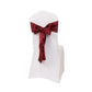 Burgundy satin chair sash bow on a white chair.