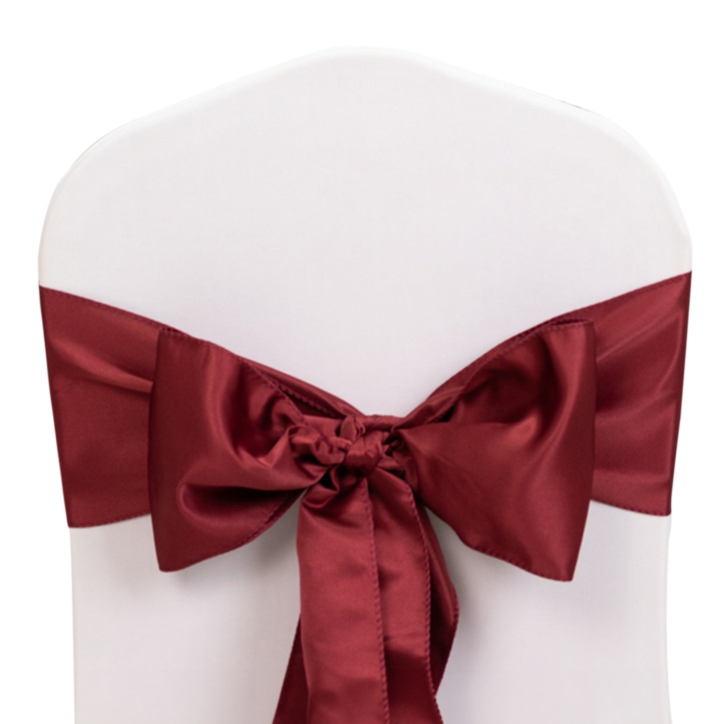 Burgundy satin chair sash bow on a white chair.