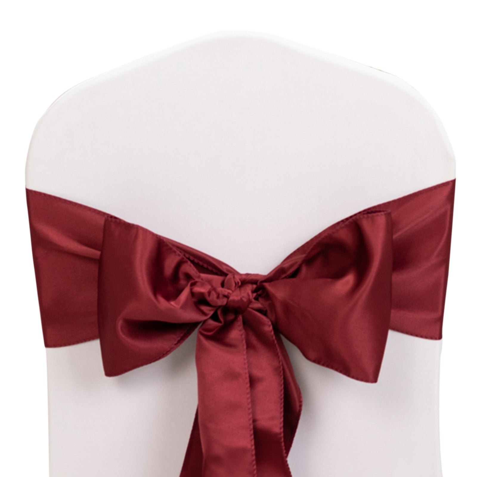 Burgundy satin chair sash bow on a white chair.