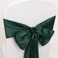 Hunter emerald green satin chair sash tied in a bow on a white chair.
