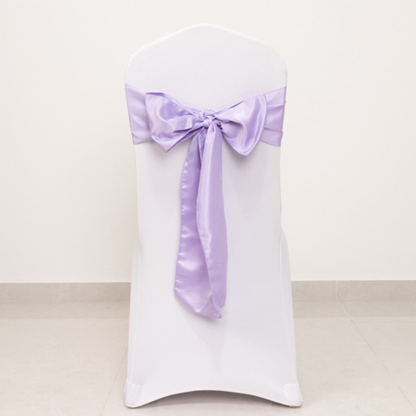 Lavender satin chair sash with bow for elegant decor.