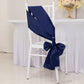 Navy blue satin chair sash and bow on a white chair.