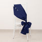 Navy blue satin chair sash elegantly tied on a white chair.