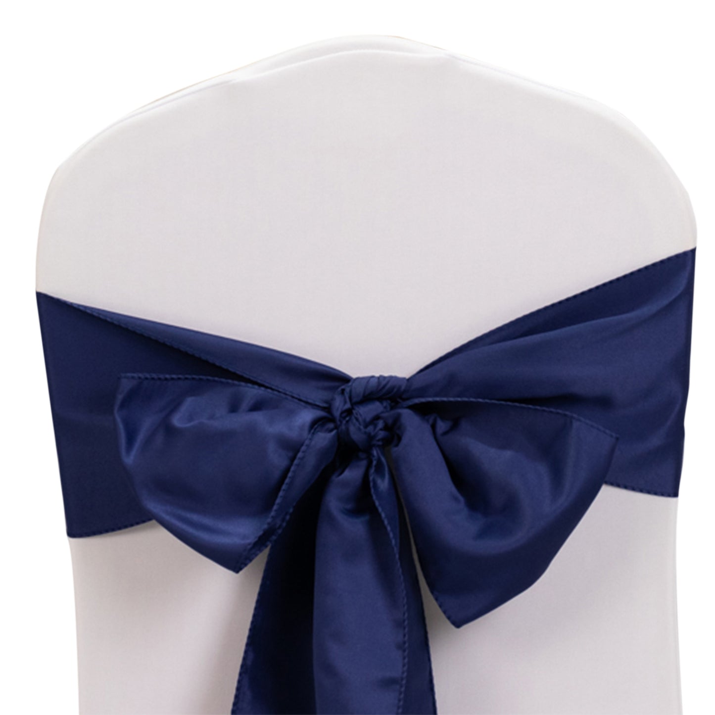 Navy blue satin chair sash with bow on a white chair.