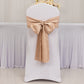 Nude satin chair sash bow on a white chair for elegant decor.