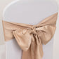 Nude satin chair sash bow on a white chair.