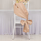 Nude satin chair sash and bow on a white chair.