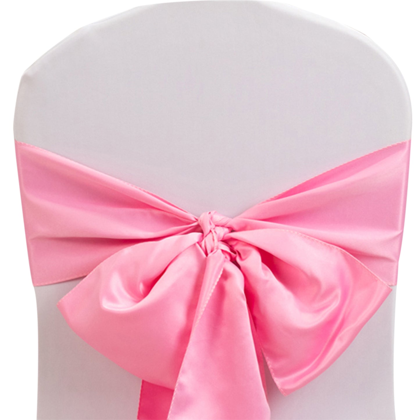 Pink satin chair sash bow on a white chair.