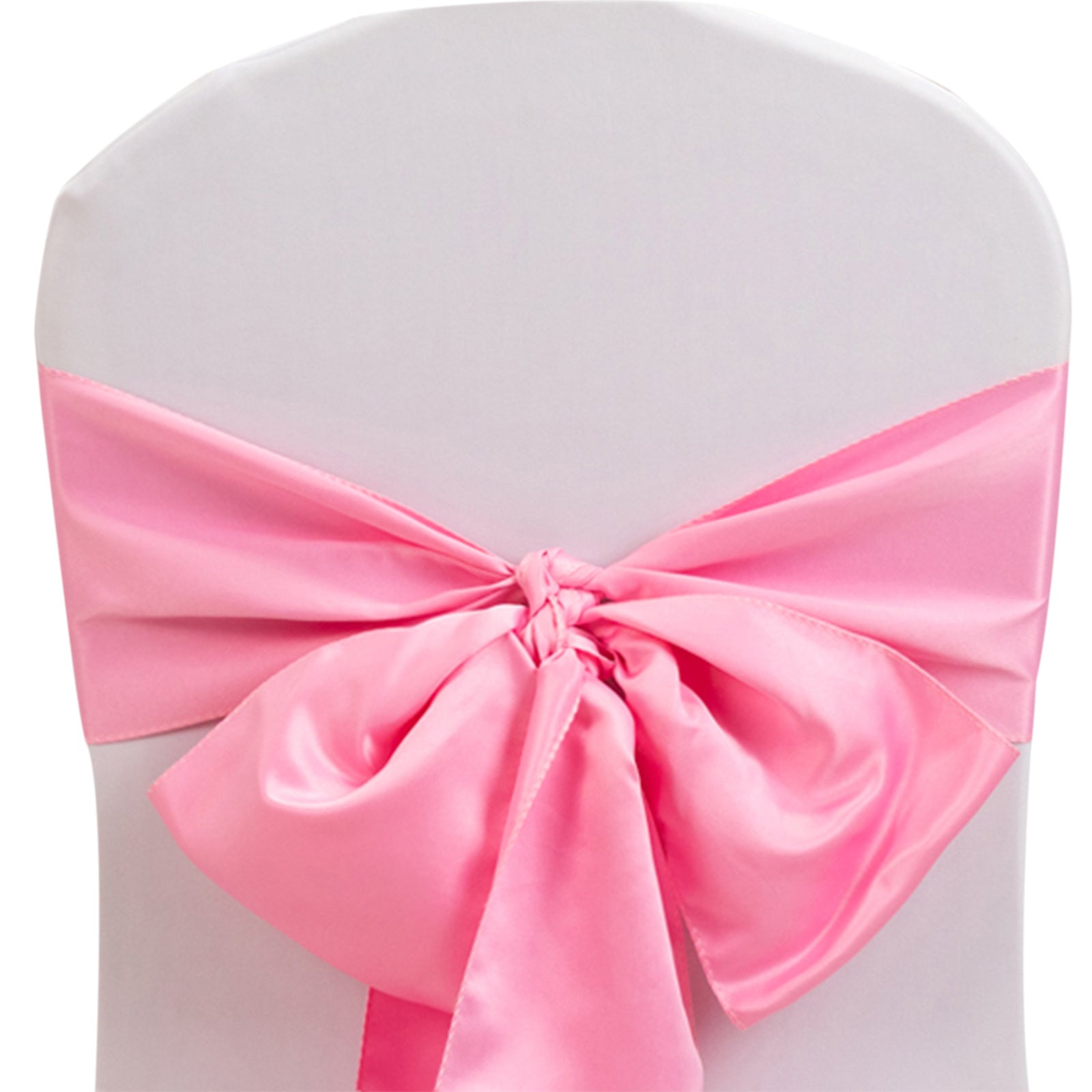Pink satin chair sash bow on a white chair.