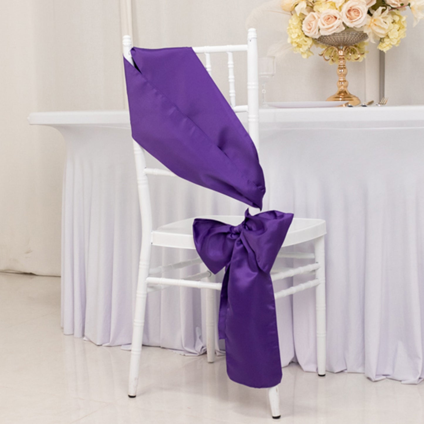 Purple satin chair sashes and bows for elegant décor.