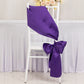 Purple satin chair sash and bow on a white chair.