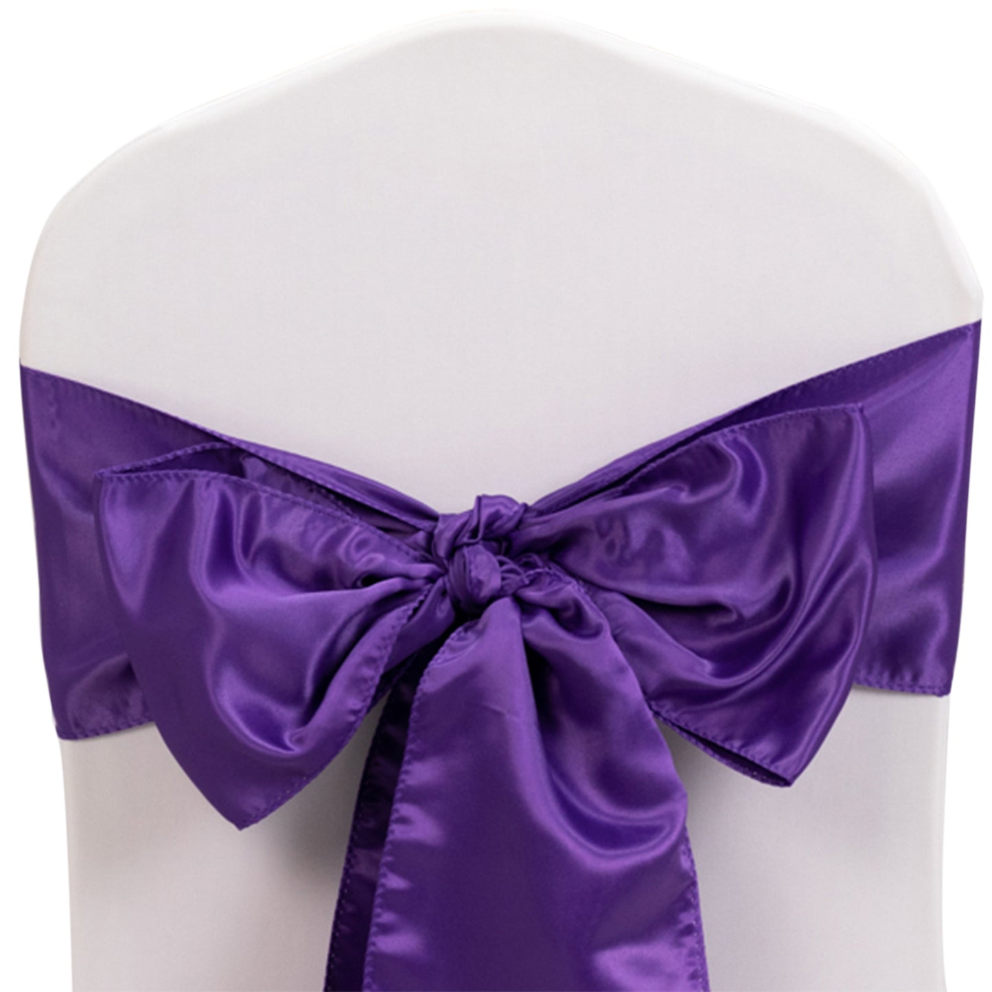 Purple satin chair sash bow on a white chair.