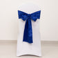 Royal blue satin chair sash bow on a white chair.