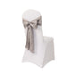 Silver satin chair sash bow on a white chair.
