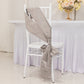 Silver satin chair sash tied in a bow on a white chair.