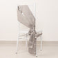 Silver satin chair sash bow on a white chair.