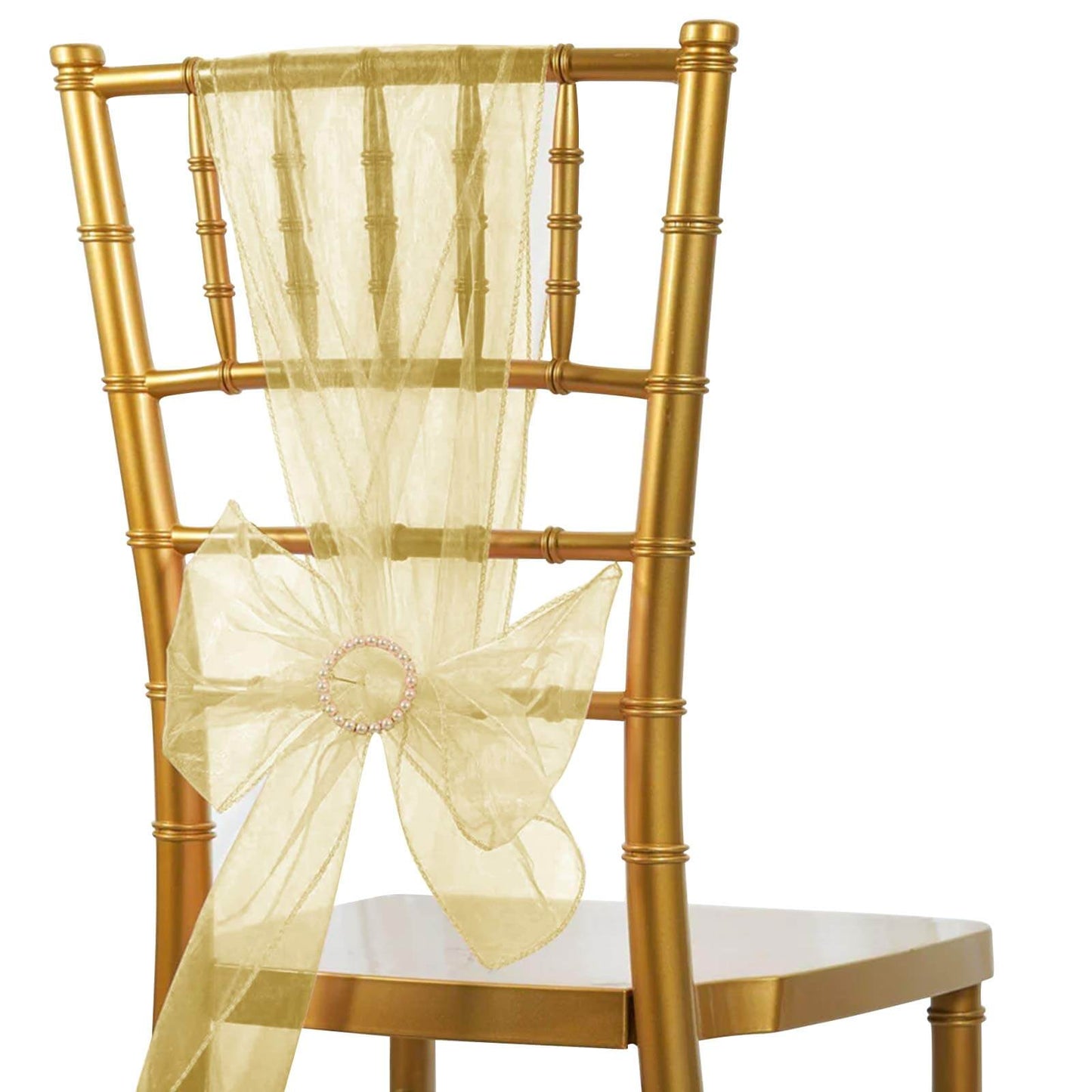 Champagne organza chair sash bow tied on a gold chiavari chair.