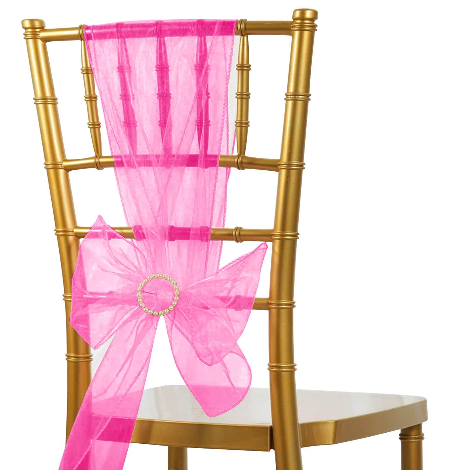 Fuchsia organza chair sash with bow on a gold chair.