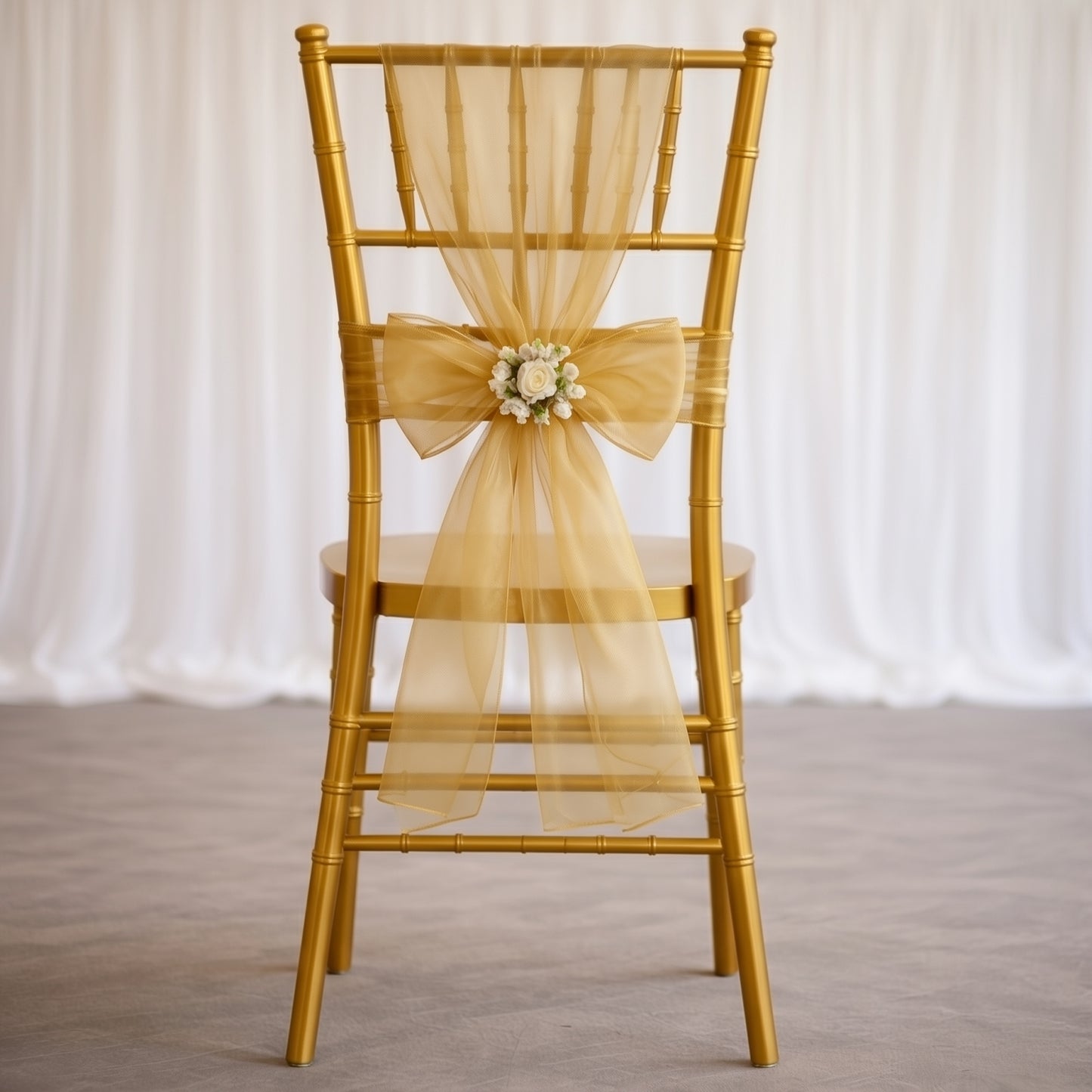 Gold organza chair sash bow on a golden chair.