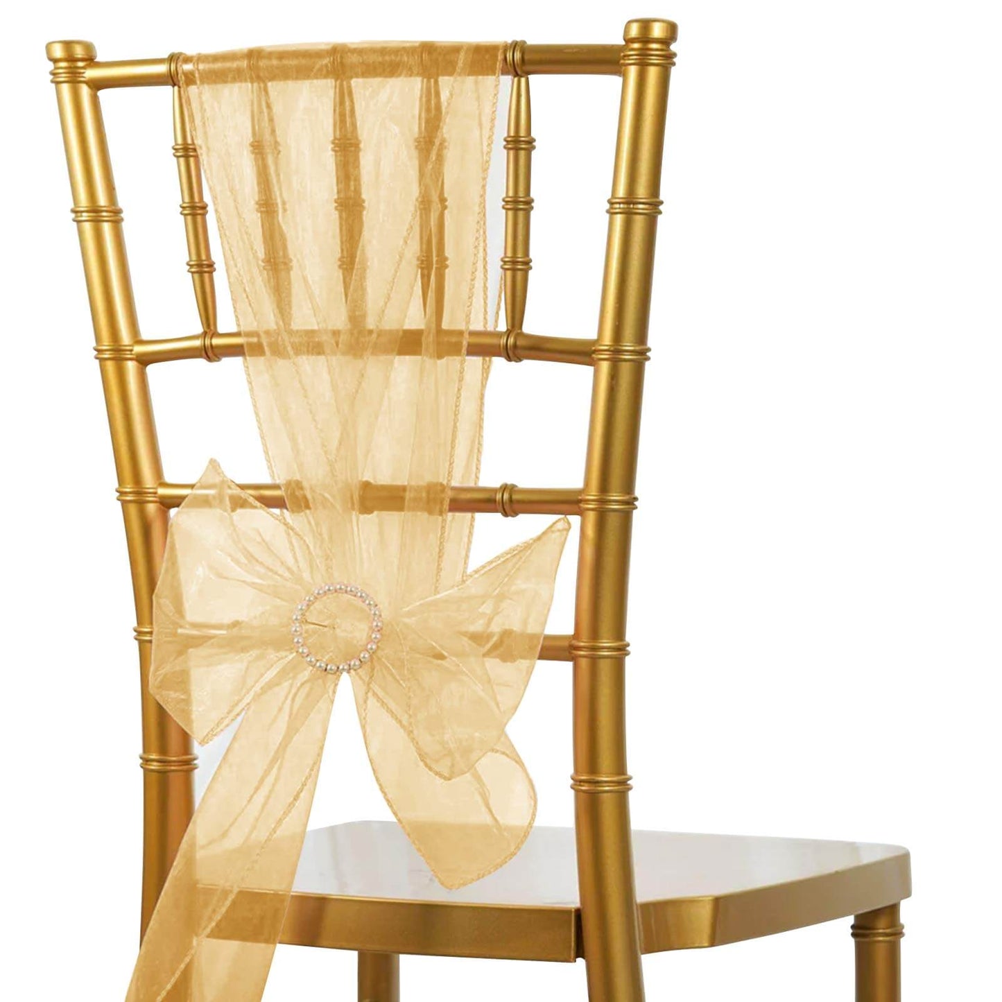 Gold organza chair sash with bow on a gold chair.