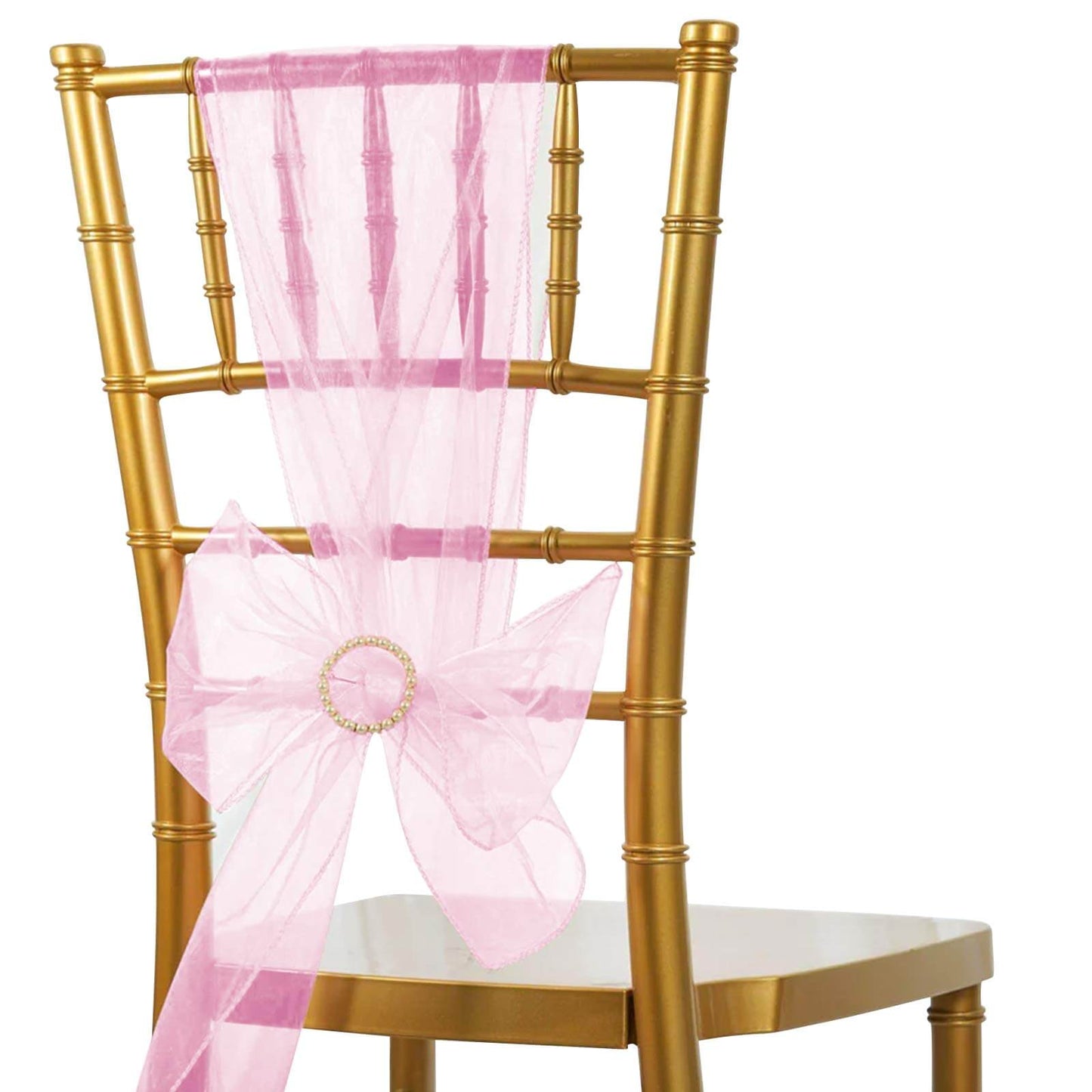 Pink organza chair sash tied in a bow on a gold chair.