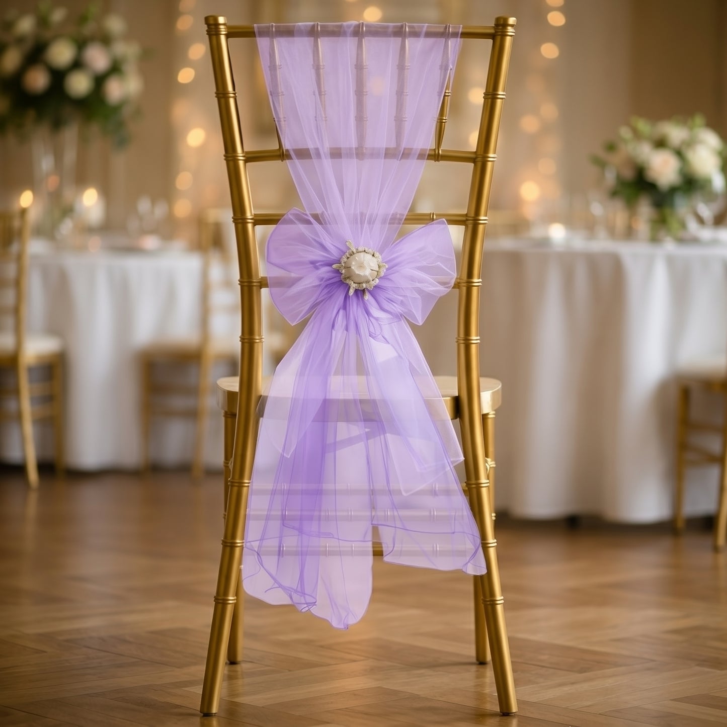 Purple organza chair sash bow on a gold chiavari chair.