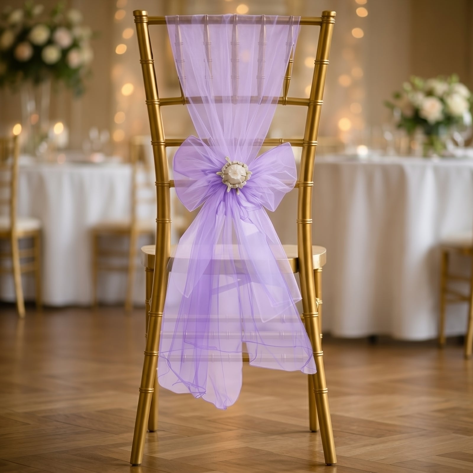 Purple organza chair sash bow on a gold chiavari chair.