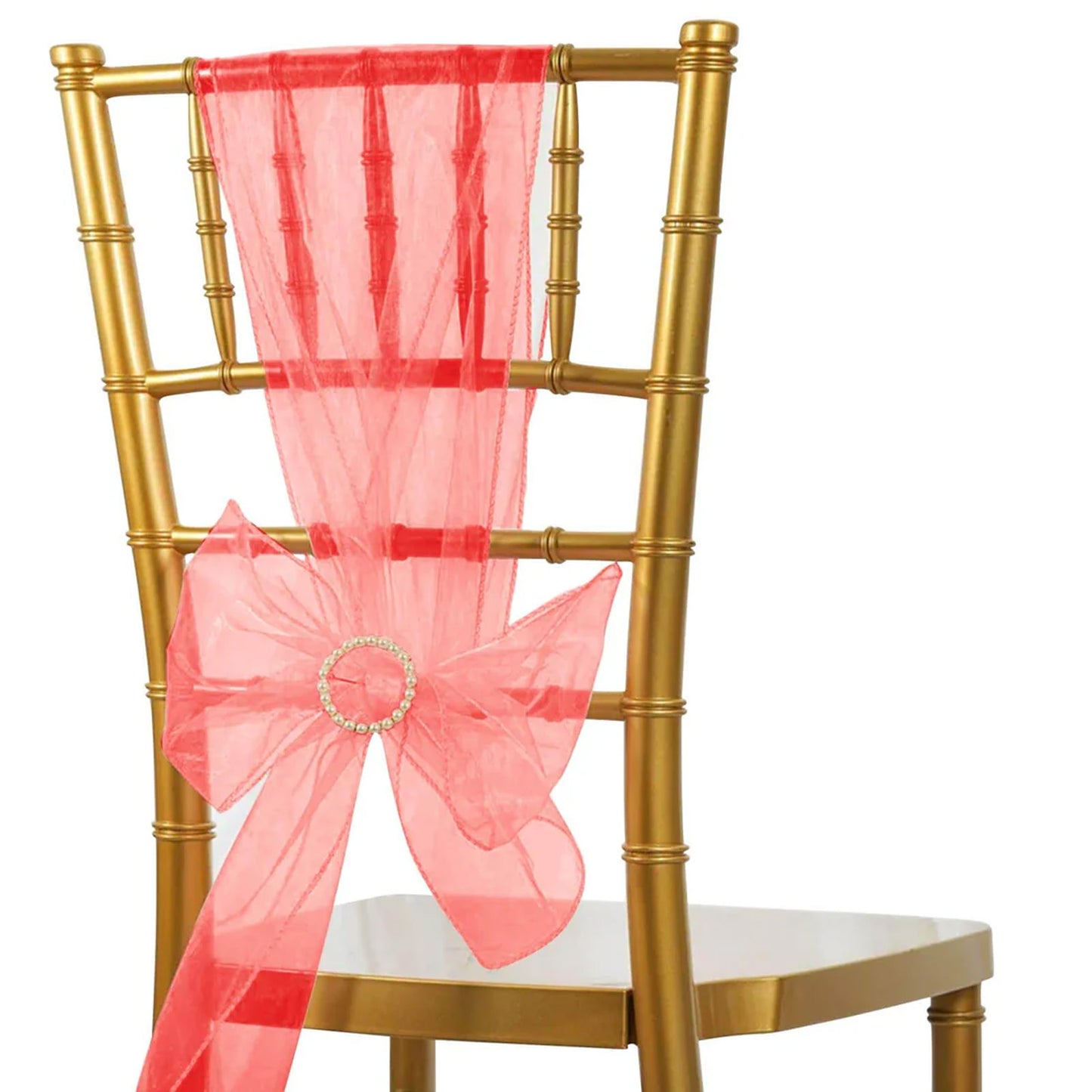 Red organza chair sash with bow on a gold chair.