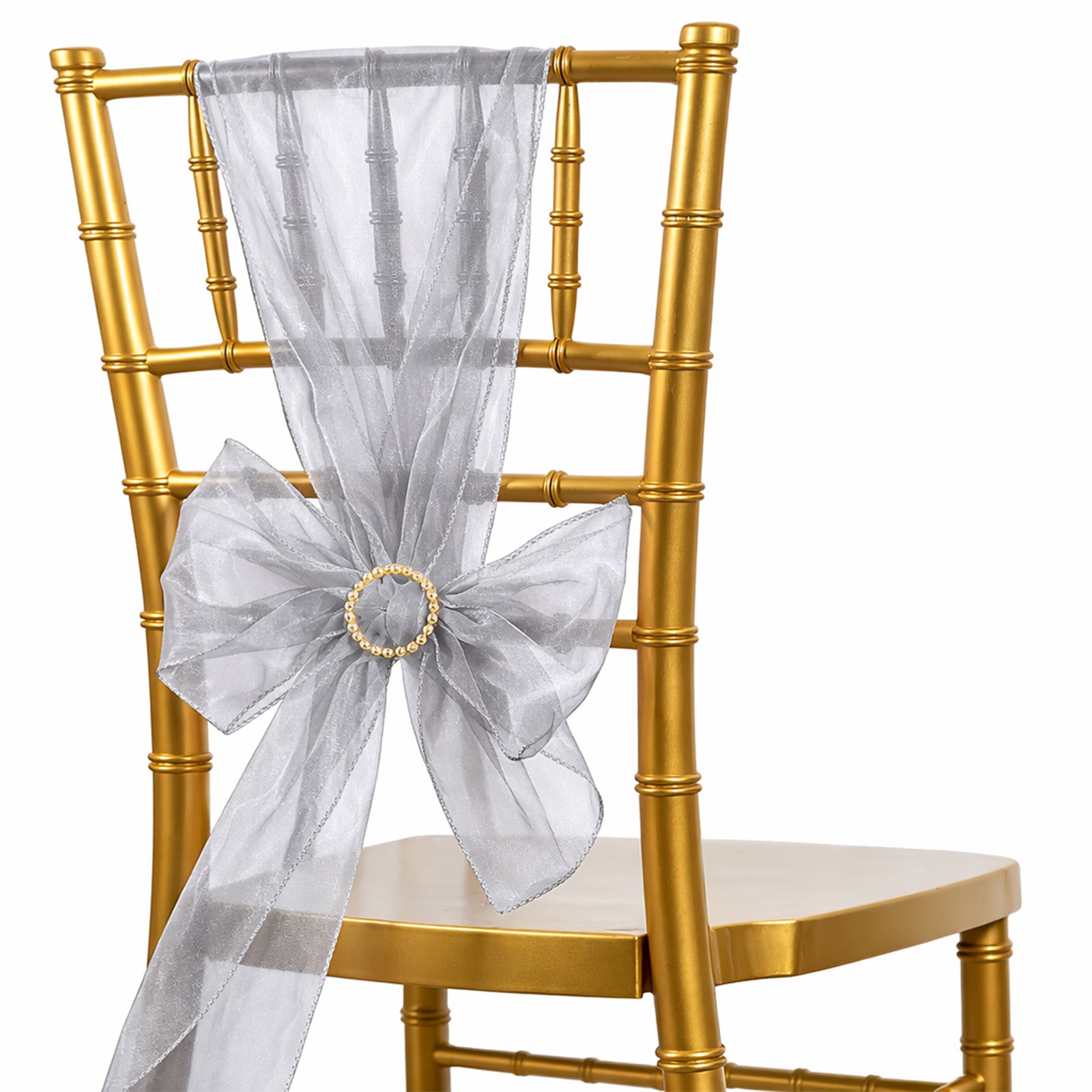 Silver organza chair sash bow on a gold chiavari chair.
