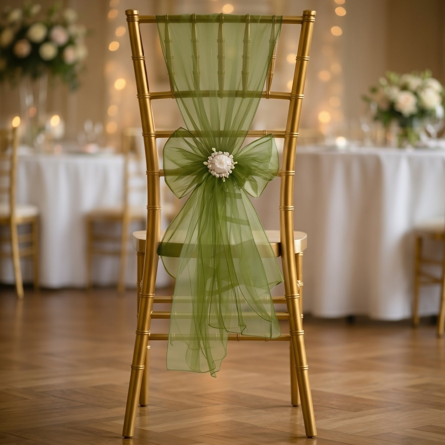 Olive green organza chair sash tied on a gold Chiavari chair.