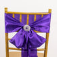Purple satin chair sash with a silver snowflake buckle and rhinestone brooch.