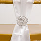 Silver snowflake chair sash band buckle with diamonds on a white ribbon.