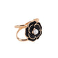 Black pearl floral metal chair sash bow pin with gold rim.