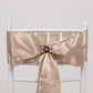 Black pearl floral chair sash bow pin with gold rim.